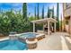 A luxurious backyard with a pool, spa, fireplace, and seating area for outdoor enjoyment at 10671 Capesthorne Way, Las Vegas, NV 89135