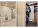 A modern bathroom featuring a large soaking tub, walk-in shower, and an open doorway to the walk-in closet at 10671 Capesthorne Way, Las Vegas, NV 89135