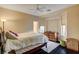 Cozy bedroom featuring a bay window, natural light, and hardwood floors at 10671 Capesthorne Way, Las Vegas, NV 89135