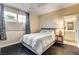 Comfortable bedroom with a large window, stylish curtains, and an ensuite bathroom at 10671 Capesthorne Way, Las Vegas, NV 89135