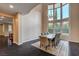Bright dining room featuring high ceilings, large windows, hardwood flooring, and a stylish chandelier at 10671 Capesthorne Way, Las Vegas, NV 89135