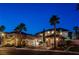 Well-manicured home exterior with mature palm trees and an attached three-car garage at 10671 Capesthorne Way, Las Vegas, NV 89135