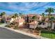 An eye-level aerial view of a home with a three-car garage, well-manicured landscaping, and a tile roof at 10671 Capesthorne Way, Las Vegas, NV 89135