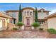 Stunning two-story home with a rotunda entrance, beautiful stone accents, and desert landscaping at 10671 Capesthorne Way, Las Vegas, NV 89135