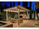 Pergola over outdoor fireplace and lounge area in backyard at 10671 Capesthorne Way, Las Vegas, NV 89135