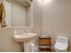 Charming half bathroom with pedestal sink and decorative basket at 10671 Capesthorne Way, Las Vegas, NV 89135