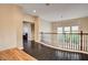 Second floor hallway featuring dark wood floors and a wooden railing at 10671 Capesthorne Way, Las Vegas, NV 89135