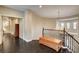 Second floor hallway featuring dark wood floors and a wooden railing at 10671 Capesthorne Way, Las Vegas, NV 89135