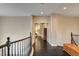 Second floor hallway featuring dark wood floors and a wooden railing at 10671 Capesthorne Way, Las Vegas, NV 89135