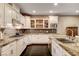 Bright kitchen featuring granite countertops, custom cabinetry, and stainless steel appliances at 10671 Capesthorne Way, Las Vegas, NV 89135