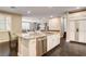 Spacious kitchen with stainless steel appliances, a large island, and sleek dark wood flooring at 10671 Capesthorne Way, Las Vegas, NV 89135