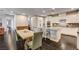 Spacious kitchen with granite countertops, modern stainless steel appliances, and island with seating at 10671 Capesthorne Way, Las Vegas, NV 89135