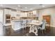 Bright kitchen features white cabinets, stainless steel appliances, granite counters, and an island at 10671 Capesthorne Way, Las Vegas, NV 89135