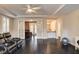 Spacious living room with ceiling fan, wood floors, and French doors leading to office space at 10671 Capesthorne Way, Las Vegas, NV 89135