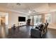Spacious living room with hardwood floors, recessed lighting, and a sliding glass door to the patio at 10671 Capesthorne Way, Las Vegas, NV 89135