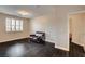 A cozy loft featuring hardwood floors, shuttered windows, and an open doorway, creating a welcoming atmosphere at 10671 Capesthorne Way, Las Vegas, NV 89135