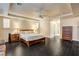 Bright main bedroom features a ceiling fan, hardwood floors, and an open hallway leading to the bathroom at 10671 Capesthorne Way, Las Vegas, NV 89135