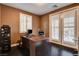 Cozy home office with dark wood flooring and a desk by the window at 10671 Capesthorne Way, Las Vegas, NV 89135