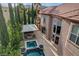 Backyard showcasing a pool, jacuzzi, and outdoor living area with fireplace at 10671 Capesthorne Way, Las Vegas, NV 89135