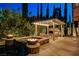 Backyard featuring a jacuzzi with fire bowls and an outdoor fireplace under a pergola at 10671 Capesthorne Way, Las Vegas, NV 89135