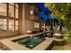 Backyard jacuzzi featuring stone accents and surrounded by landscaping at 10671 Capesthorne Way, Las Vegas, NV 89135