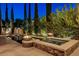 Luxury backyard features include in-pool lounge chairs and a stone-clad jacuzzi with fire bowls at 10671 Capesthorne Way, Las Vegas, NV 89135