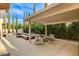 An outdoor patio with a fireplace, pool, spa, and seating, perfect for relaxation and entertainment at 10671 Capesthorne Way, Las Vegas, NV 89135