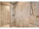 Modern tiled shower with dual shower heads and contrasting fixtures, providing a luxurious bathing experience at 10671 Capesthorne Way, Las Vegas, NV 89135