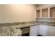Granite countertops and a wine rack outfit this stylish wet bar at 10671 Capesthorne Way, Las Vegas, NV 89135