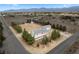 An aerial view of a two-story home with a large lot, detached garage, desert landscaping, and mountain views at 1160 Huracan St, Pahrump, NV 89048