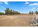 Backyard featuring gravel, trees, outbuildings and staircase leading up to the back porch at 1160 Huracan St, Pahrump, NV 89048