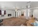 A spacious basement featuring a fireplace, ceiling fans, support columns, and wall to wall carpeting at 1160 Huracan St, Pahrump, NV 89048