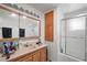 Bathroom featuring a wooden vanity with a peach countertop and a shower with sliding glass doors at 1160 Huracan St, Pahrump, NV 89048