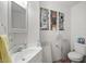Bathroom featuring white sink, toilet, and heater with access panel to electrical and plumbing at 1160 Huracan St, Pahrump, NV 89048