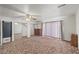 Spacious bedroom features a ceiling fan, window coverings, and mirrored closet doors at 1160 Huracan St, Pahrump, NV 89048