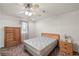Cozy bedroom with a ceiling fan, natural light and carpet flooring at 1160 Huracan St, Pahrump, NV 89048