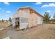 House exterior showing peach siding, white trim, and a two-door garage at 1160 Huracan St, Pahrump, NV 89048