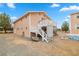 Two story house with peach siding, white trim, and a raised patio at 1160 Huracan St, Pahrump, NV 89048
