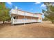 Exterior shot of home with peach siding, white trim, and covered patio area at 1160 Huracan St, Pahrump, NV 89048