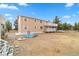 Exterior view of two story house featuring a back porch and a above ground pool at 1160 Huracan St, Pahrump, NV 89048