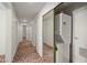 Hallway has a closet with a stacked washer and dryer with mirrored doors at 1160 Huracan St, Pahrump, NV 89048