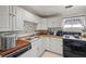 A cozy kitchen featuring white cabinets, laminate countertops, and a stainless-steel sink at 1160 Huracan St, Pahrump, NV 89048