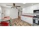 Eat-in kitchen area featuring white cabinetry and adjacent laundry area at 1160 Huracan St, Pahrump, NV 89048