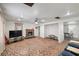 An open living room with a fireplace, ceiling fan, carpeting, and lots of space for entertaining at 1160 Huracan St, Pahrump, NV 89048