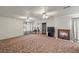 A living room with wood fireplace and carpeting throughout at 1160 Huracan St, Pahrump, NV 89048