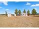 Outbuildings with white siding and red trim on a large lot at 1160 Huracan St, Pahrump, NV 89048