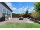 Backyard features a built-in barbeque, artificial turf, brick pavers, and cozy fire pit area at 1609 Dream Canyon Ave, North Las Vegas, NV 89084