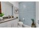 Stylish bathroom with light blue subway tile wall, modern vanity, and tasteful decor at 1609 Dream Canyon Ave, North Las Vegas, NV 89084