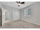 Spacious bedroom featuring carpet flooring, a ceiling fan, and closet, offering both style and functionality at 1609 Dream Canyon Ave, North Las Vegas, NV 89084