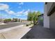 View of gray stucco home with desert landscaping and a brick driveway at 1609 Dream Canyon Ave, North Las Vegas, NV 89084